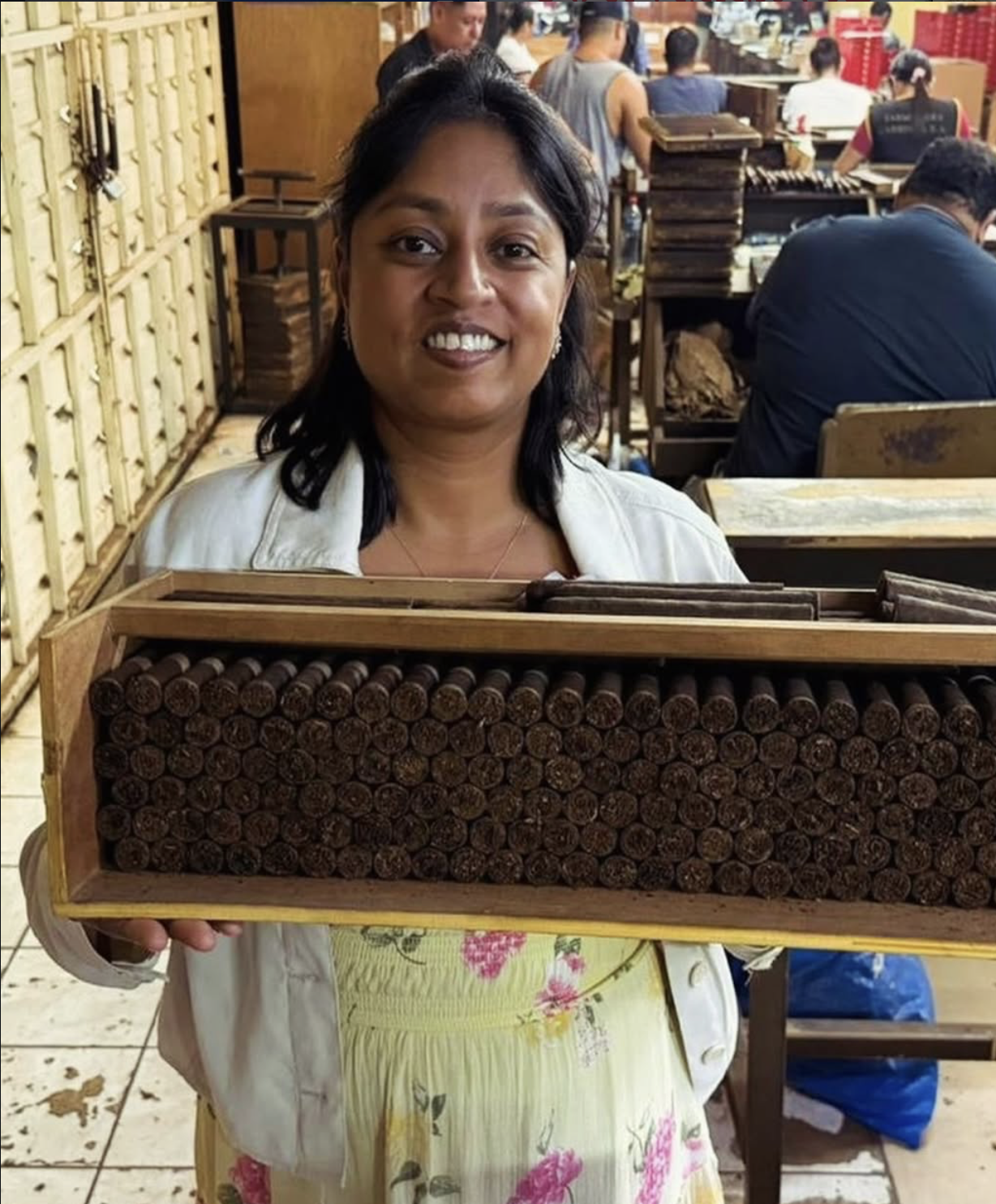 A Tabacalera Carreras team member holding a tray of hand-rolled cigars