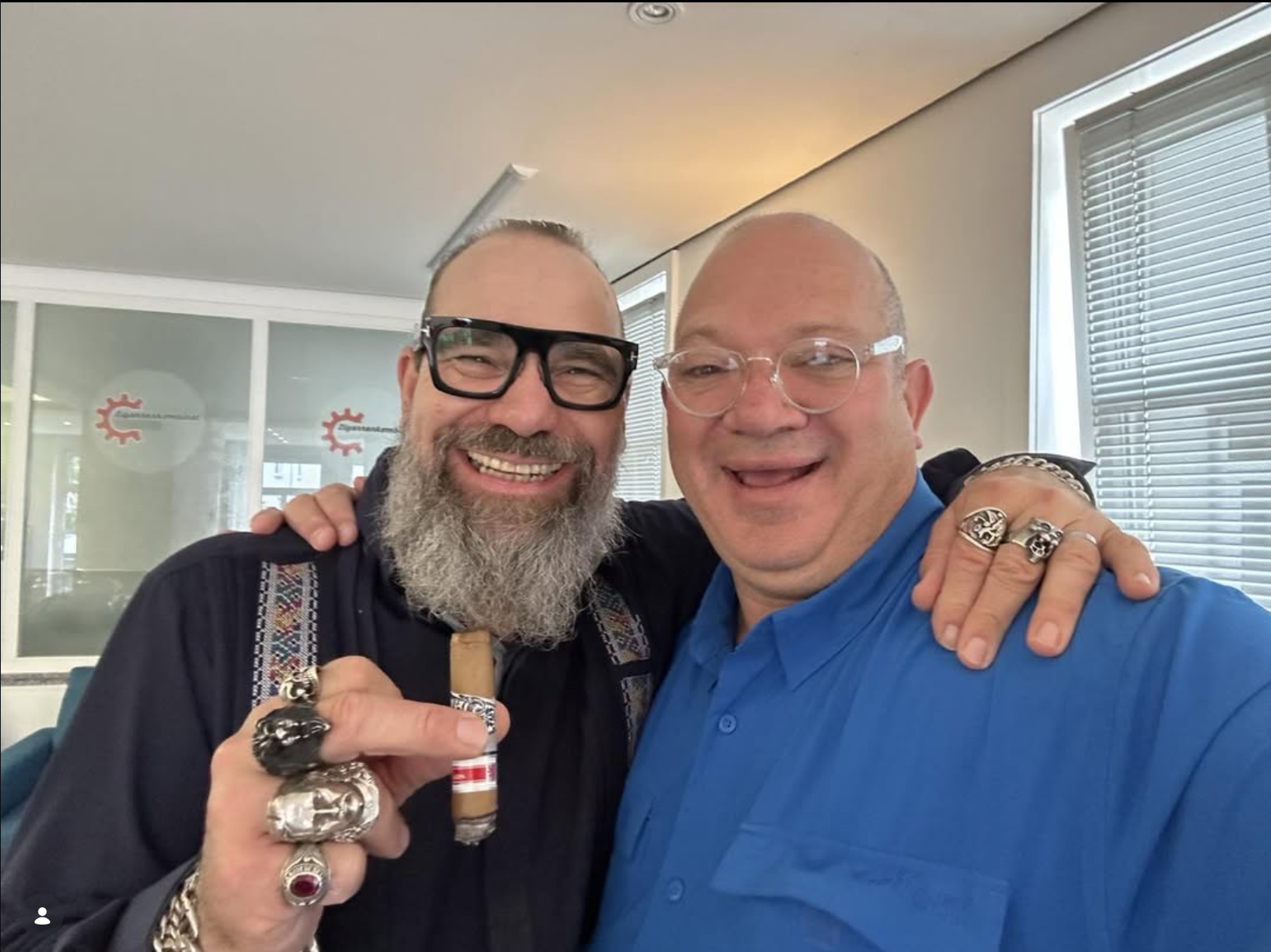 Two Esteban Carreras collaborators sharing a cigar