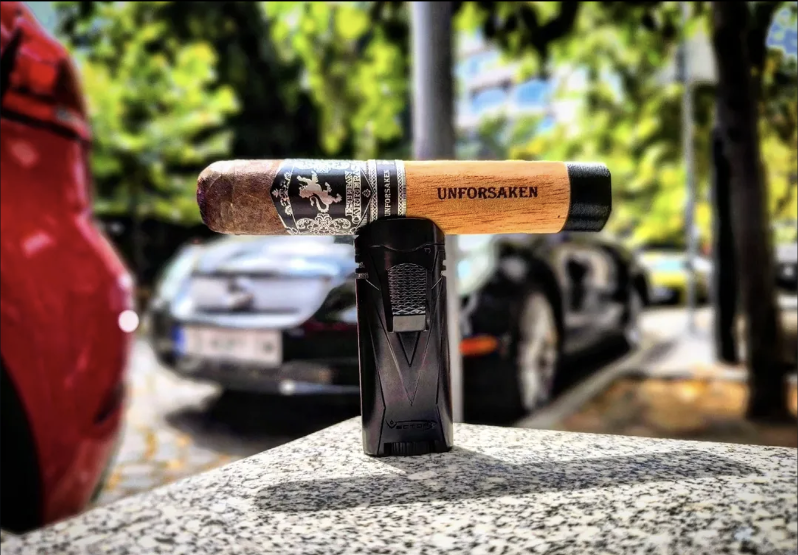 An Esteban Carreras Unforsaken cigar balanced on a torch lighter